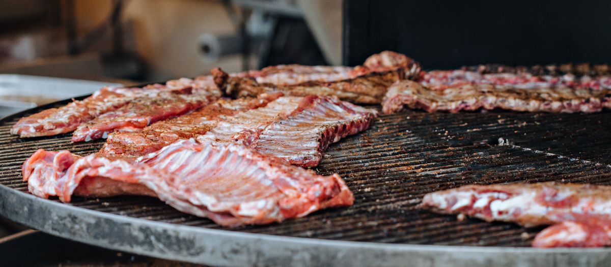 Close-up of delicious ribs grilling on a barbecue, perfect for a savory feast.