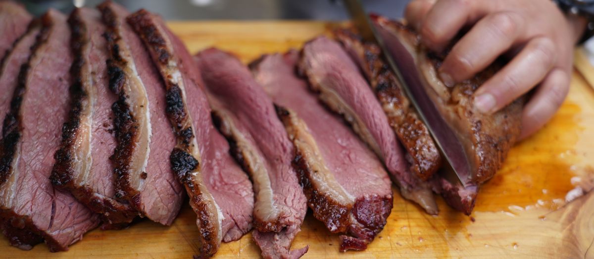 Brisket and ribs cooking low and slow on a pellet grill.